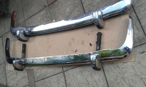 A stainless steel new bumper on a Rover P5 being compared to the chrome plated original.